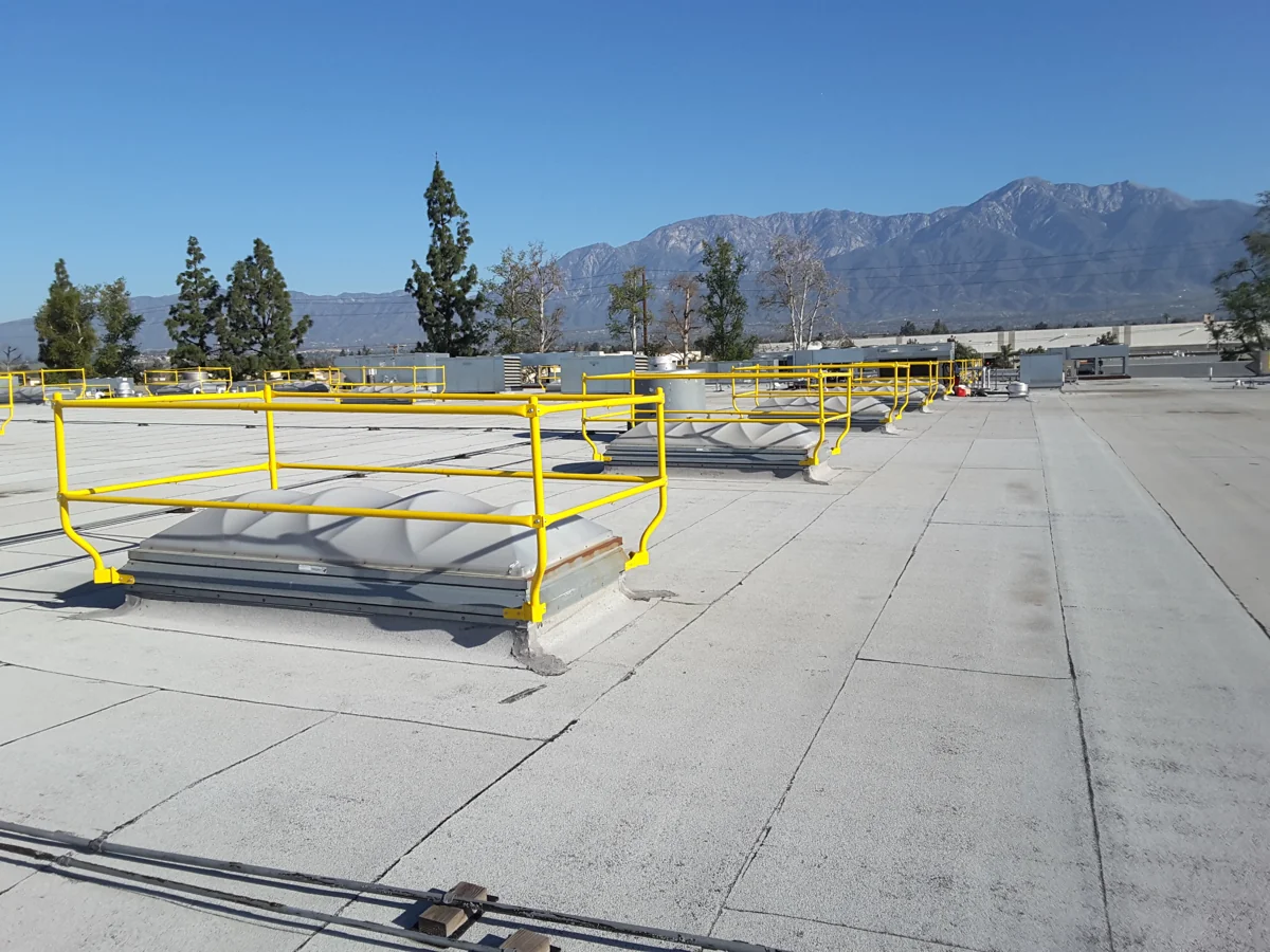 Yellow LES guardrails installed around rooftop smoke vents