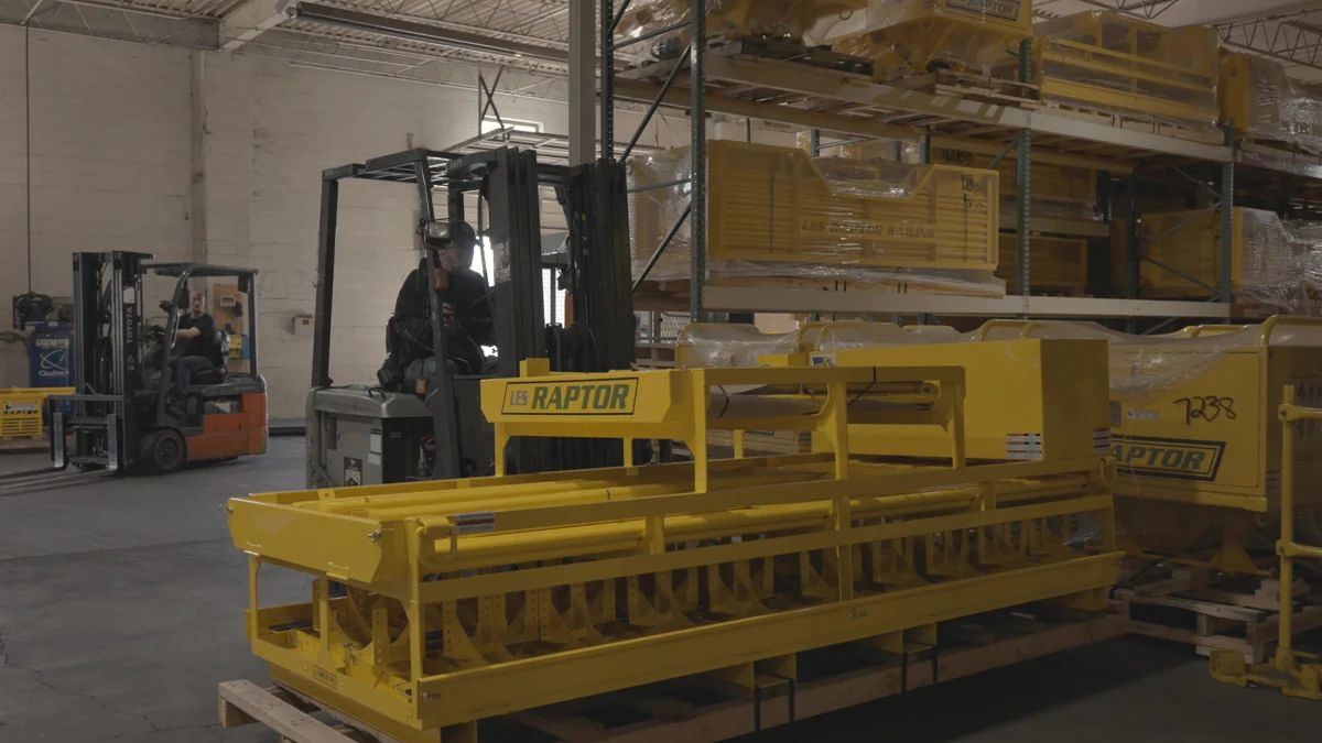 Forklift operators and completed yellow LES products in the warehouse